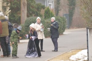 Ein Kind und einige Erwachsene stehen auf einer Straße